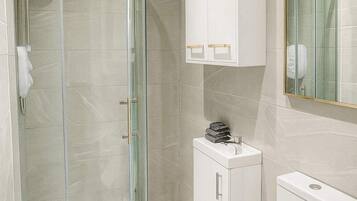 Shower, hair dryer, towels, shampoo