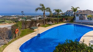 A swimming pool with a view of the sea, palm trees, and a lifebuoy. - Private Jacuzzi for Romantic Getaways a221 (Mijas Costa)