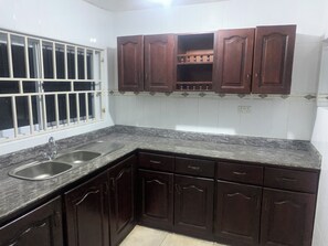 Full-size fridge, microwave, stovetop, cookware/dishes/utensils - Chapel Hill 2-Bedroom Apartment (Takoradi)