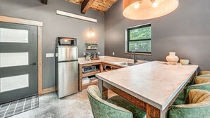 A modern kitchen with a large island, built-in appliances, and a rustic ceiling. - Secluded Modern Cabin- Near Flathead Lake (Polson)