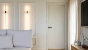 A bedroom with a bed, a door, and a nightstand with a lamp. - Nordic Zen 2BR Beach House • Bali-Inspired Calm (Vārzas)