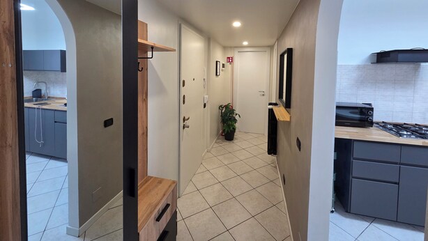 A modern kitchen with a gas stove, a microwave, and a sink. - RHO FIERA FLAT- 100 M FROM THE METRO (Pero)