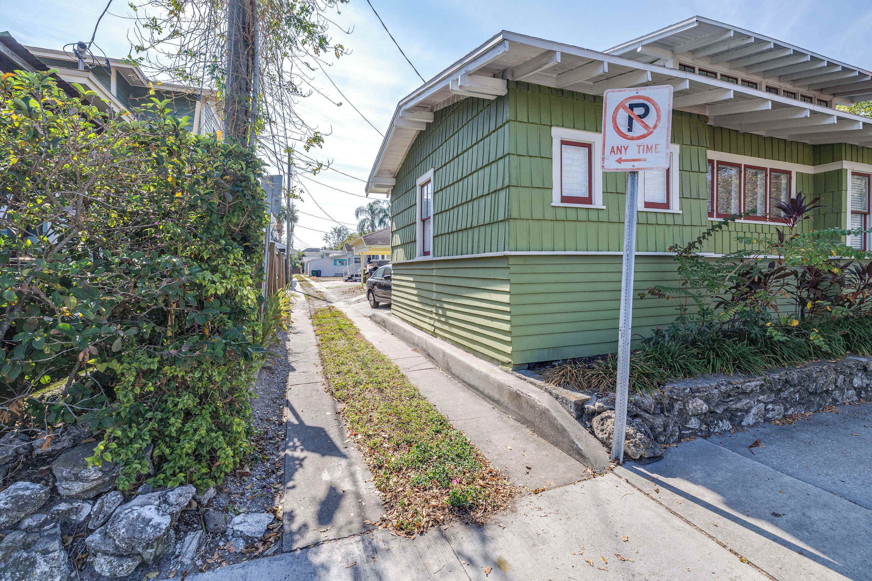 A green building with a no parking sign.