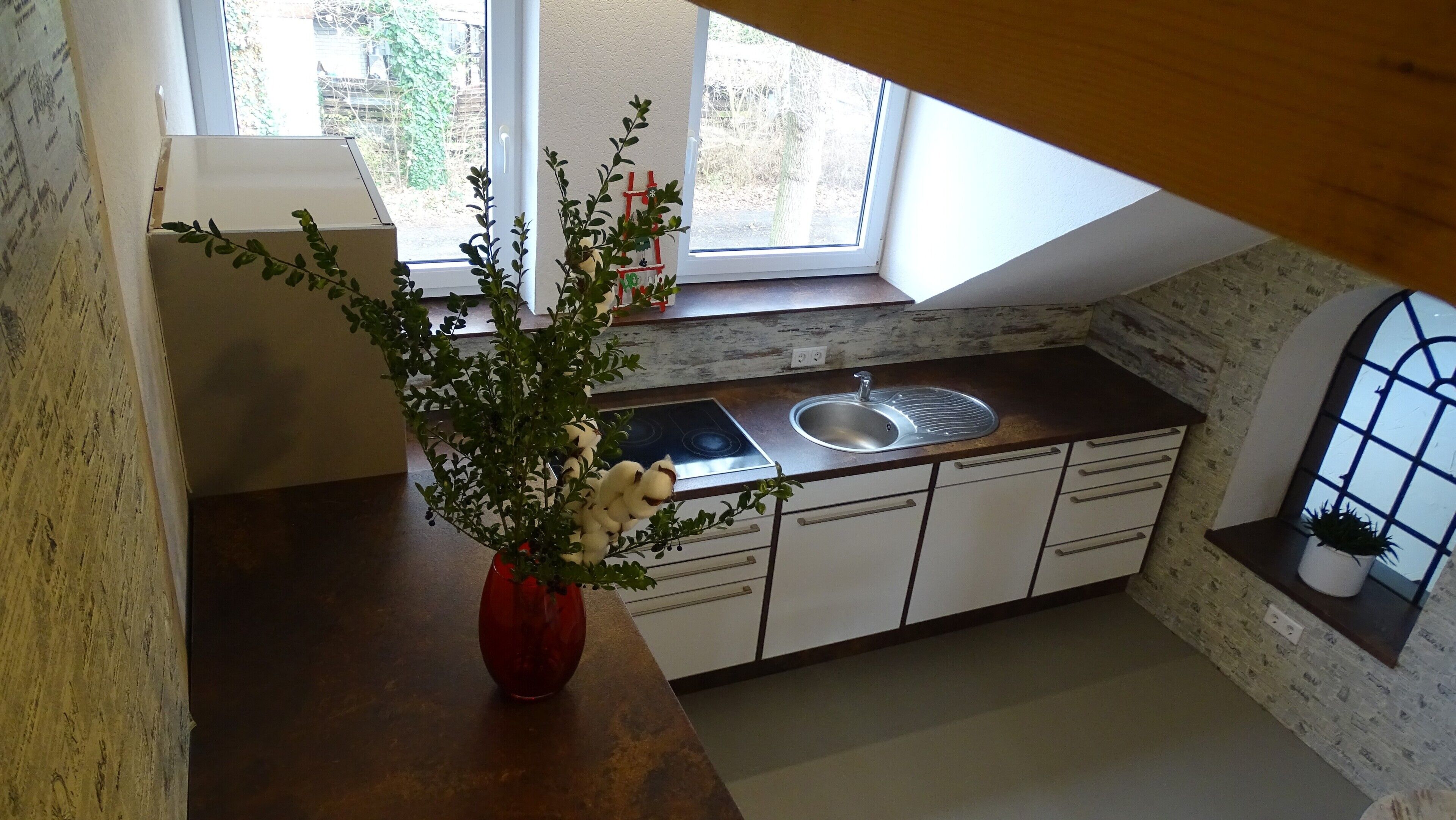 Una cocina con ventana, pileta y cocina.