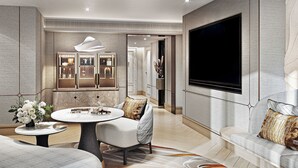 Ein modernes Wohnzimmer mit rundem Couchtisch, einer Couch, einem an der Wand befestigten Fernseher und einer dekorativen Kommode.