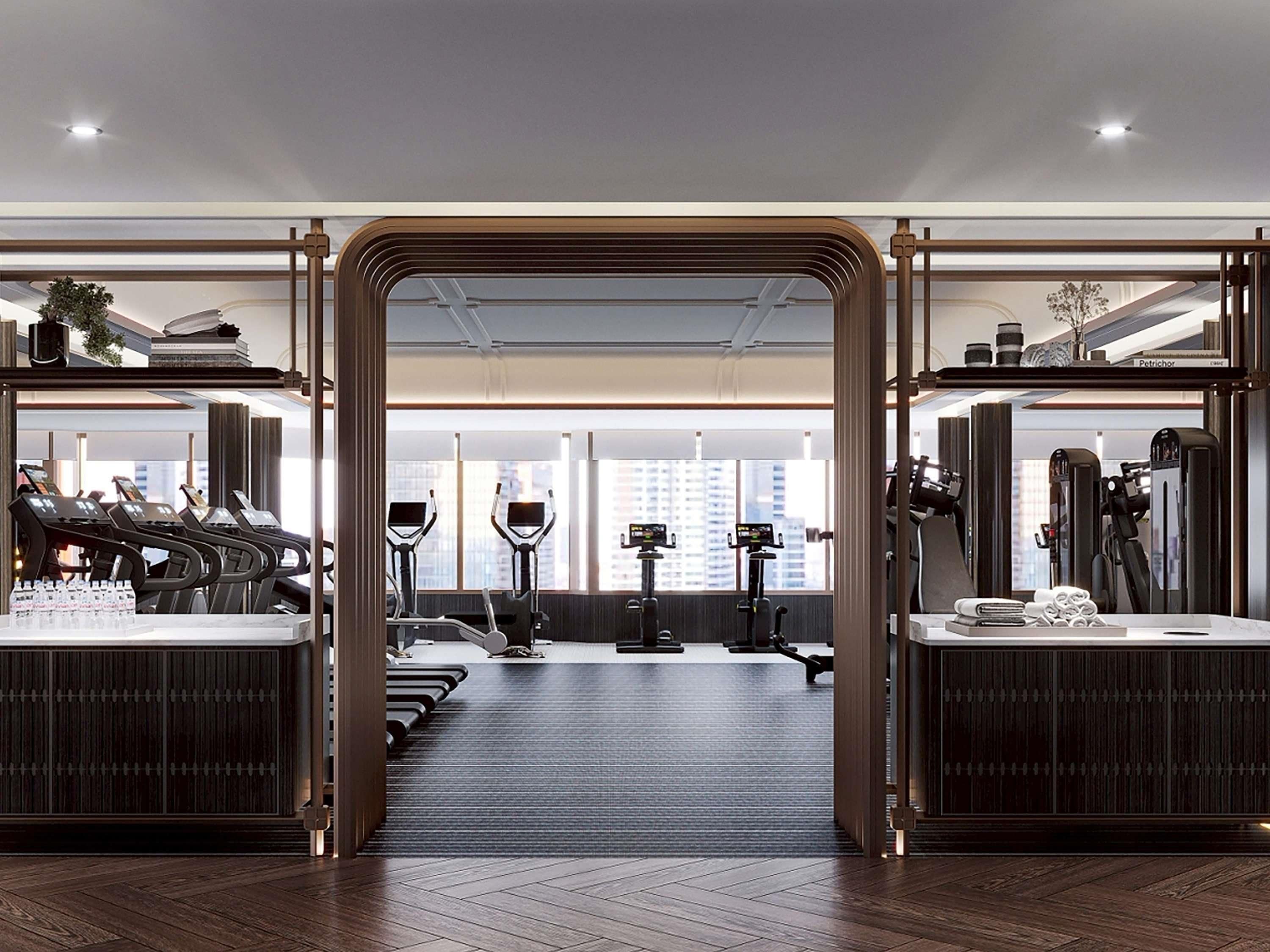 A modern gym with treadmills, elliptical machines, and weight equipment.