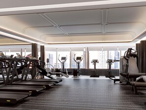 Een moderne sportschool met loopbanden, elliptische trainers en gewichten.