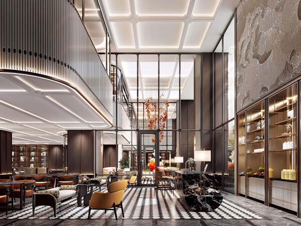 A spacious lobby with a high ceiling, a central staircase, and a seating area with sofas and tables. - Fairmont Bangkok Sukhumvit (Bangkok)