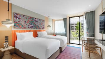 A hotel room with two beds, a large window with a view, a desk, and a television.