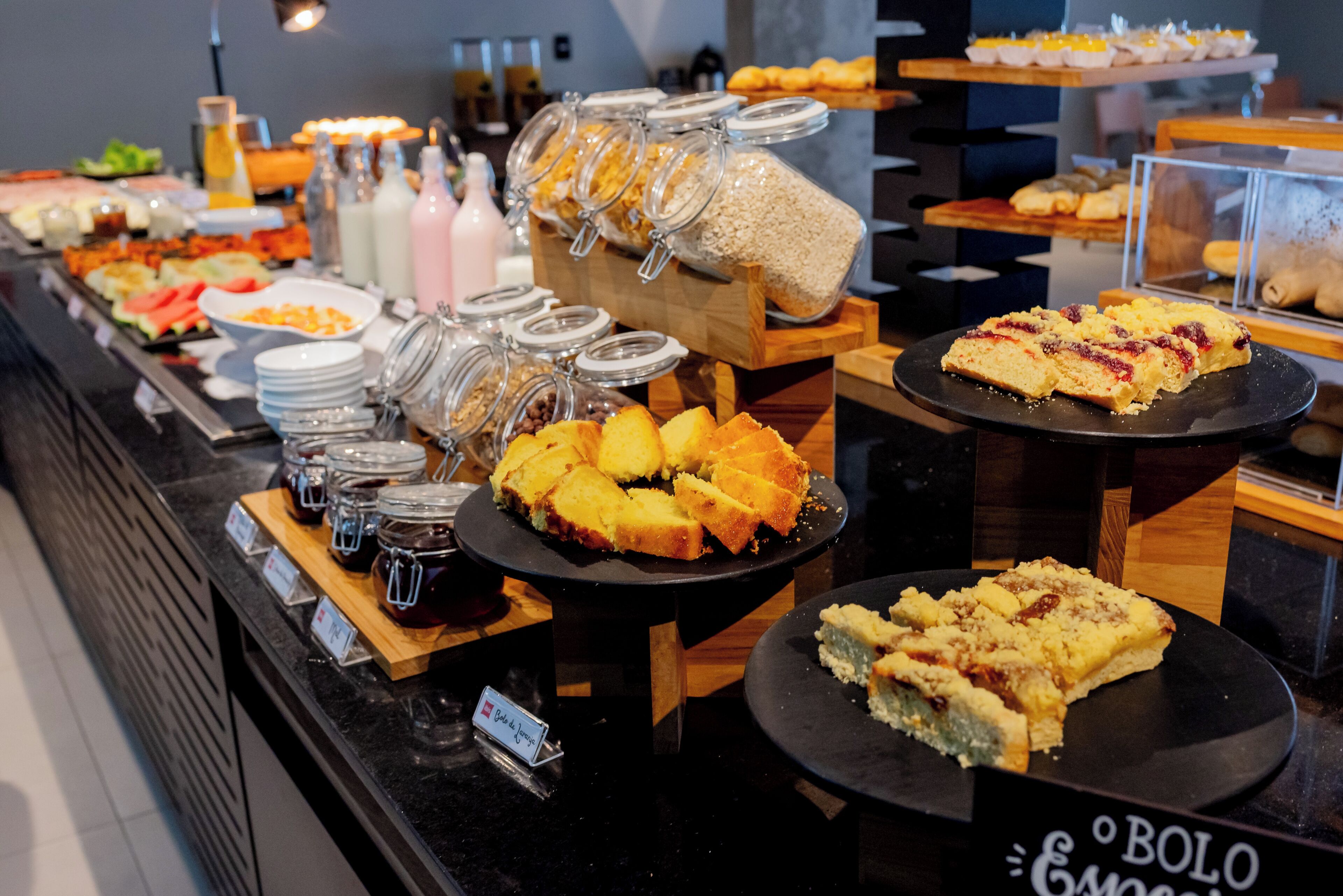 A buffet with various food items and condiments.