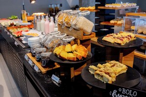 A buffet with various food items and condiments. - ibis Pelotas (Pelotas)