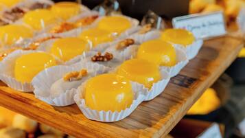 A display of yellow confections in paper cups.