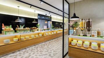 A breakfast buffet with various food items and a coffee station.