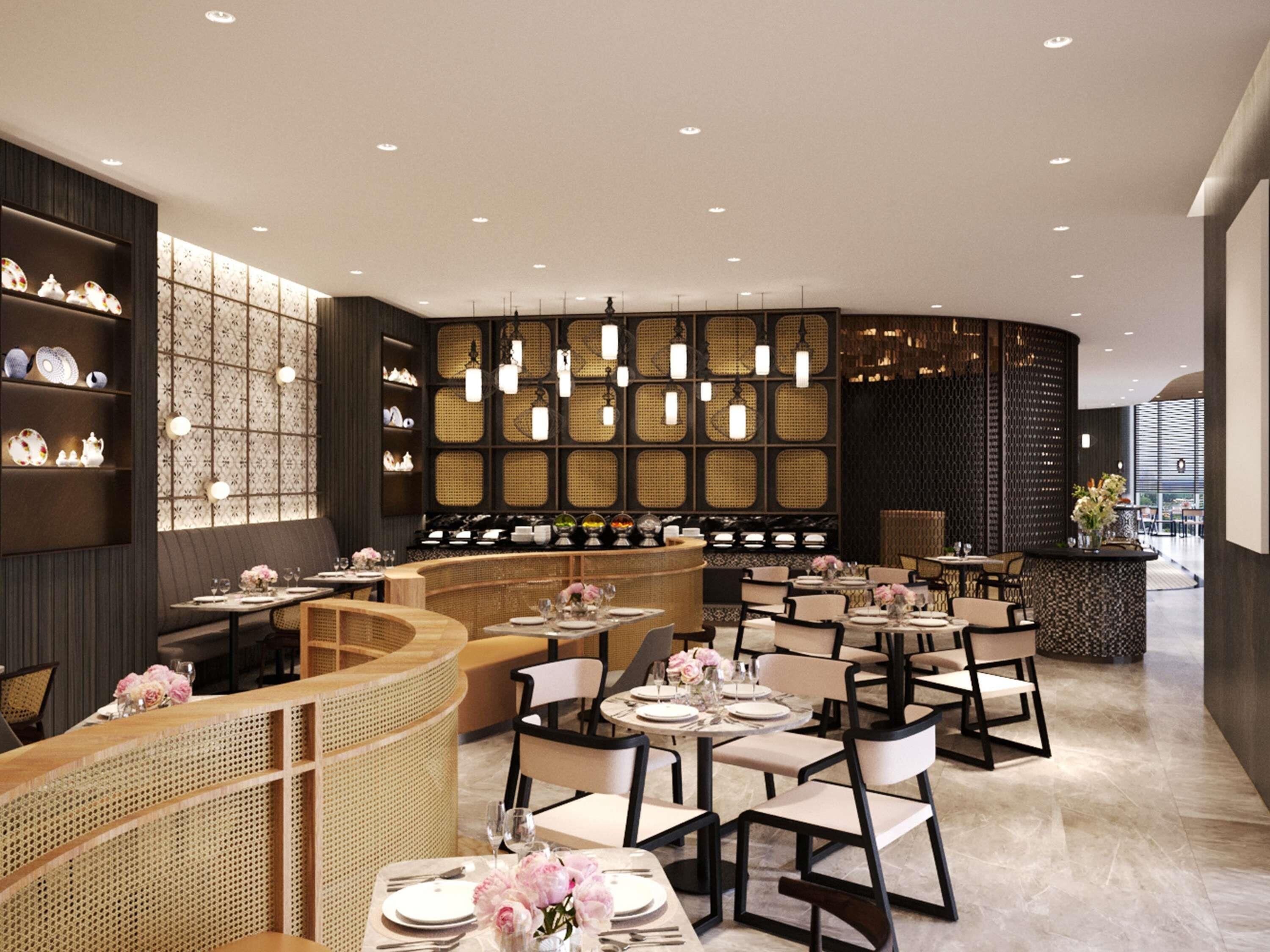 A modern restaurant interior with a curved seating area, multiple tables, and a decorative wall with shelves.