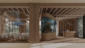 A modern interior with wooden beams, a reception desk, and a large aquarium. - Rixos Phu Quoc Vietnam - Ultra All Inclusive (Phu Quoc)