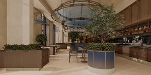 Un vaste espace intérieur aménagé avec des coins salon, une plante décorative centrale et un bar.