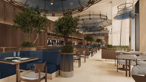A spacious restaurant with high ceilings, wooden paneling, and modern lighting fixtures. - Rixos Phu Quoc Vietnam - Ultra All Inclusive (Phu Quoc)