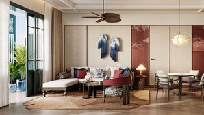 A modern living room with a sofa, chairs, a dining table, and a ceiling fan. - Rixos Phu Quoc Vietnam - Ultra All Inclusive (Phu Quoc)