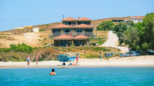 A coastal property with a large house, a beach, and a clear view of the sea. - Amari stone apartments (Lemnos)