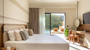 A modern hotel room with a large bed, a desk, a chair, a TV, and a view of the outdoors. - Kakkos Terra Blu (Ierapetra)