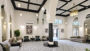 A spacious lobby with a patterned floor, multiple seating areas, and a large chandelier. - Prime Boutique Hotel Heliopolis Terrace (Cairo)