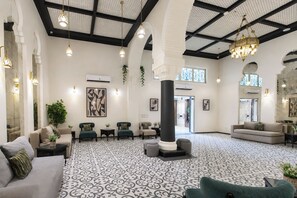 A spacious lobby with a patterned floor, multiple seating areas, and a large chandelier. - Prime Boutique Hotel Heliopolis Terrace (Cairo)