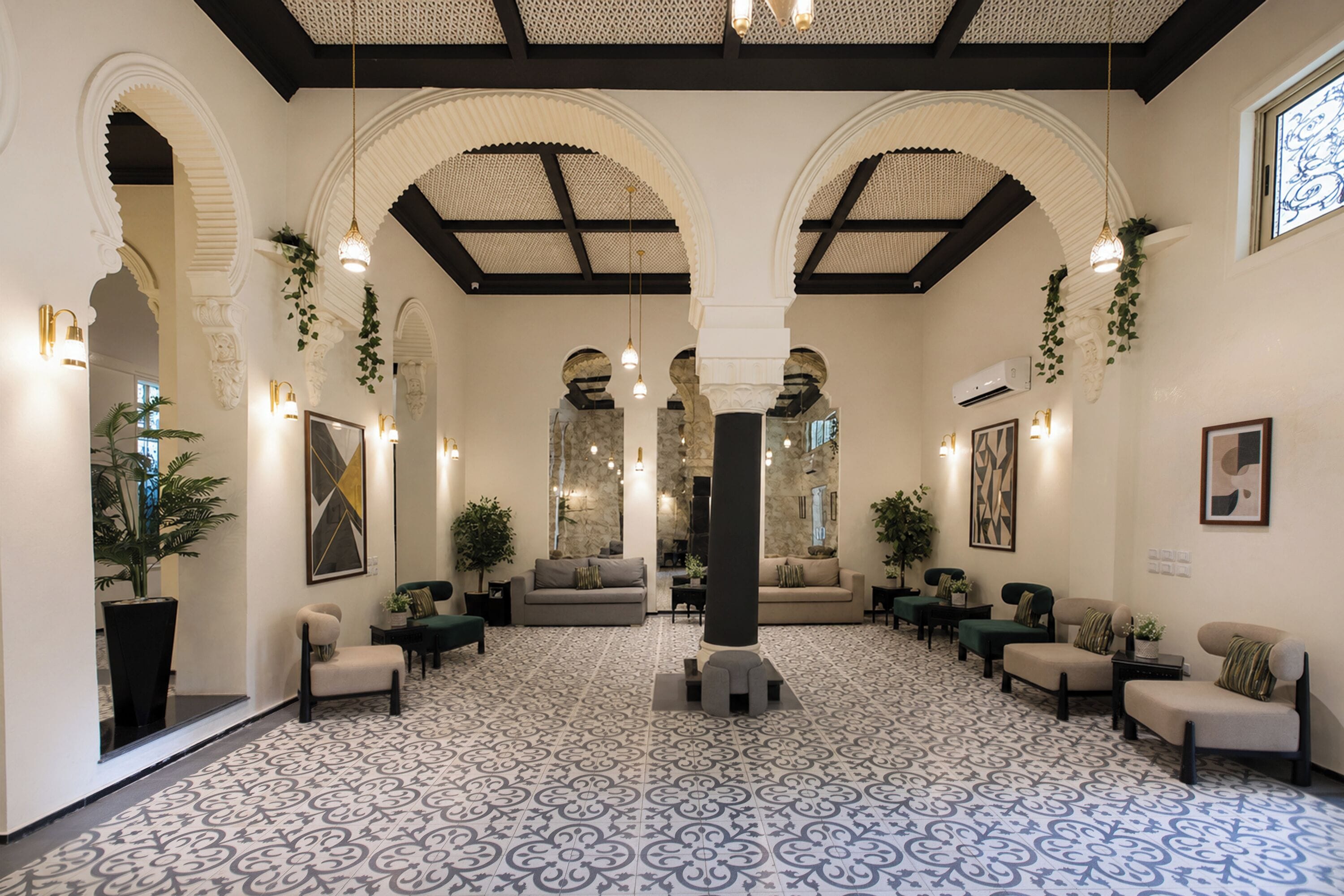 A spacious lobby with high ceilings, arches, and patterned flooring.
