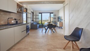 Eine moderne Küche mit Essbereich, einer Couch und einem Sessel.