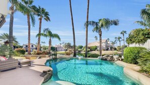 A clear swimming pool surrounded by palm trees and a well-maintained garden. - Beverly Ocotillo Chandler (Chandler)
