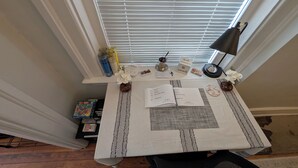 A neatly organized desk with a laptop, papers, a lamp, and decorative items. - Heart of OTR -Stadiums, Museums, Nightlife, Casino -Walkable Everywhere Cinci (Cincinnati)