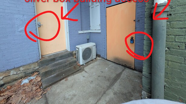 A building entrance with a blue box for apartment keys and a silver box for building access. - Heart of OTR -Stadiums, Museums, Nightlife, Casino -Walkable Everywhere Cinci (Cincinnati)