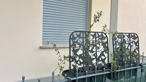 A metal fence with decorative cutouts and potted plants. - Il Torrione - Cozy Independent House for 4, between History and Relaxation (Castel Bolognese)