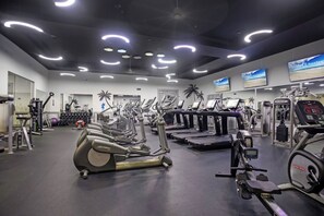 A gym with treadmills, elliptical machines, and weight machines. - The Palms Destin 2103 (Destin)