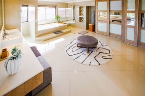 A modern bathroom with a large bathtub, a separate shower area, and a vanity with multiple sinks. - Langebaan Country Estate (Langebaan)