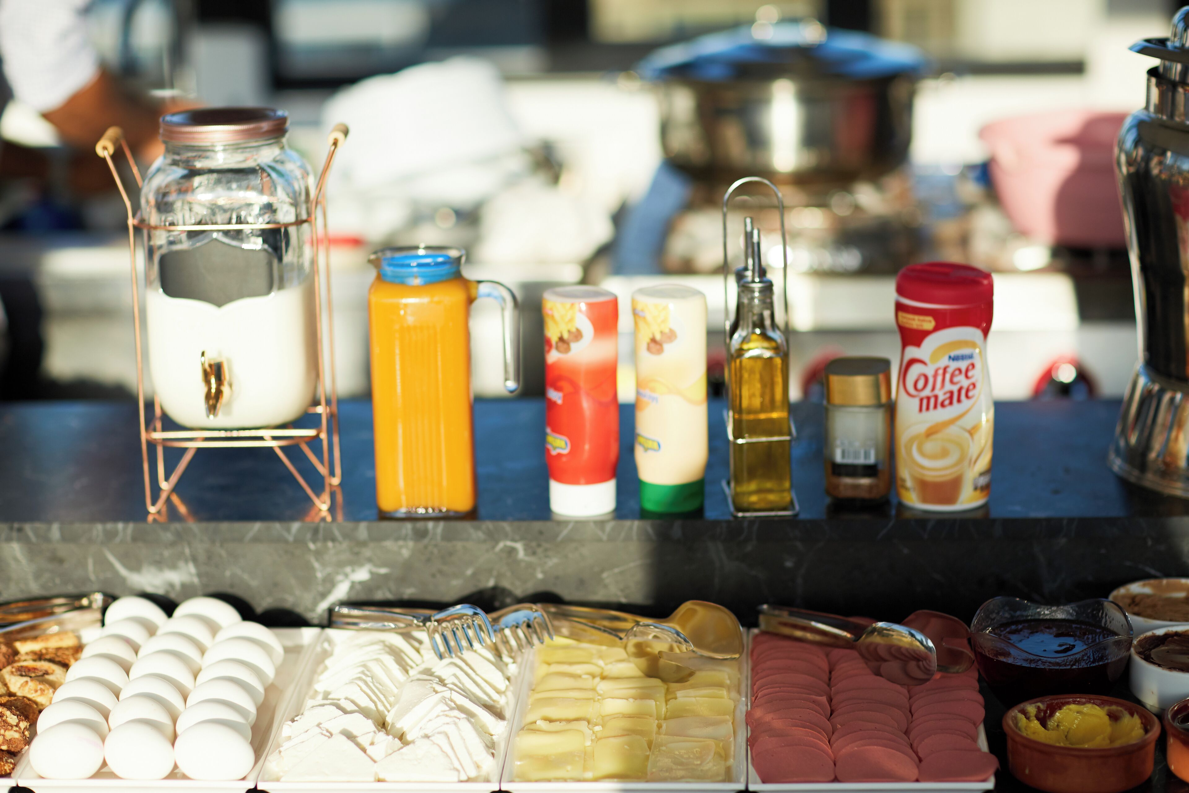 A breakfast buffet with various food items and condiments.