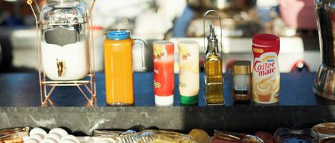 A breakfast buffet with various food items and condiments.