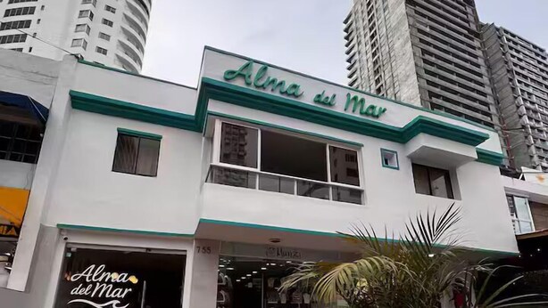 A hotel named Alma del Mar with a modern facade, a visible entrance, and a tiled pavement in front. - Alma Del Mar (Cartagena)