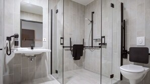 A modern bathroom with a glass-enclosed shower, a white sink, and a toilet. - B&B Hotel Würzburg-Altstadt (Würzburg)