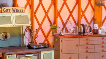 A vintage kitchen with a 'Got Wine?' sign, a vintage radio, and a wooden lattice wall.
