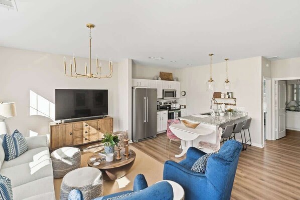 A modern living room with a sofa, coffee table, and TV. - The Blue Nest (Oxford)