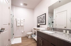 Shower, hair dryer, towels, shampoo