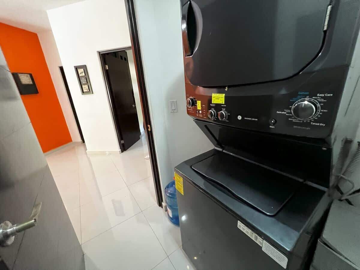 A kitchen area with a microwave, a water dispenser, and a water cooler.