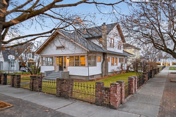 Gorgeous curb appeal, lawn, iron fence, surrounded by maple trees!