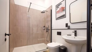 A modern bathroom with a glass-enclosed shower, a white sink, and a toilet. - Argyl | Abbey Gate: Studio 11 (Edinburgh)