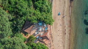 An aerial view of a beachside property with a patio area, outdoor seating, and a small building. - Camping Village Rosselba Le Palme Mobilehome Comfort for 4 persons (Portoferraio)