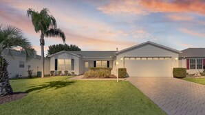 A residential property with a well-maintained lawn, a garage, and a driveway leading to the entrance. - 3/2 Beautiful Home in Summerhill (The Villages)