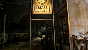 A sign for "JIWAI PALACE" with a logo, indicating the name of the establishment. - Jiwaji Palace (Khatoo)