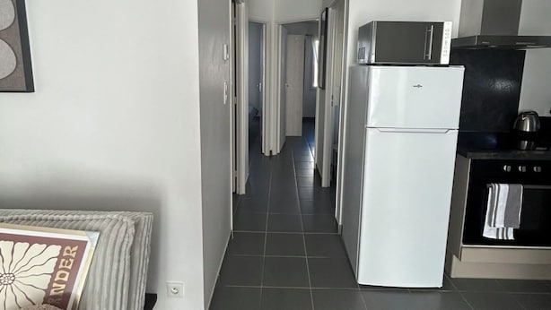 Una cocina moderna equipada con refrigerador, microondas y estufa.