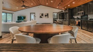 A modern kitchen with dark cabinets, stainless steel appliances, and a wooden ceiling. - Sunrise Lookout - Lakefront | Dock | Swim | Fish (Eureka)