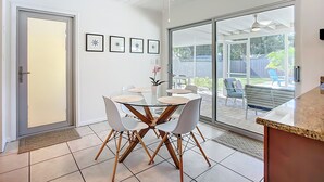 A modern kitchen with a glass door leading to a patio area. - Sunshine House - charming 2 bedroom close to Downtown and the Legacy Trail. (Sarasota)